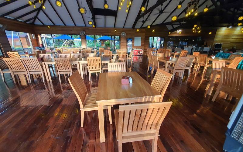 Restaurant hall with wooden floors, tables and chairs under a high timber roof at Borneo Divers Mabul Resort (placeholder, to recheck when the photo is replaced)