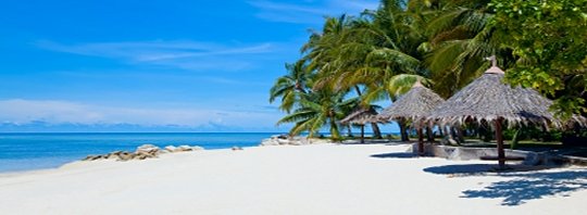White sand beach with thatched shelters, coconut palms and calm blue sea on Mabul Island (placeholder, to recheck when the photo is replaced)